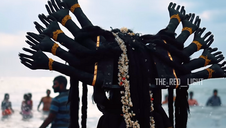 Devotee dressed as a multi-armed goddess during Kulasai Dasara festival in Kulasekarapattinam, Tamil Nadu